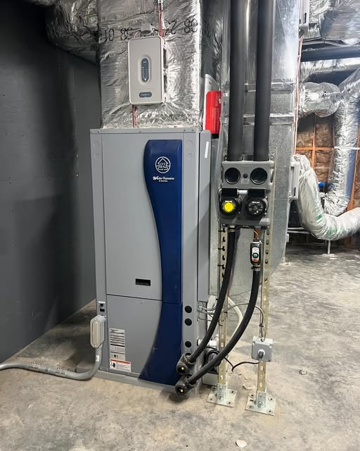 WaterFurnace geothermal heat pump installed in a mechanical room with insulated ductwork and piping.