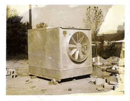 Historic commercial HVAC equipment with a large ventilation fan mounted on a metal cabinet.